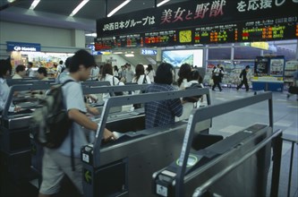 JAPAN, Honshu, Kyoto, Passengers passing through electronic ticket styles at Kyoto Station