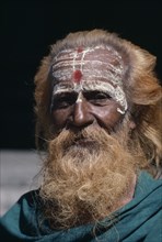 INDIA, Tamil Nadu, Tiruchirappalli, Head and shoulders portrait of a sadhu or holy man.