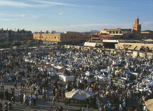 MOROCCO, Marrakech, Djemaa El Fina Square. View over busy market square with crowds of people at