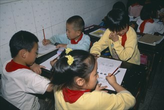 CHINA, Yunnan Province, Children studying at desks.