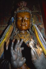 TIBET, Gyantse, Interior of the Assembly Hall with a figure of a Buddha with hands in the