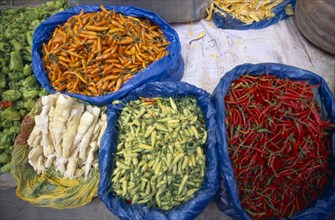 CHINA, Yunnan, Kunming, Covered food market with displays of fresh chillies.