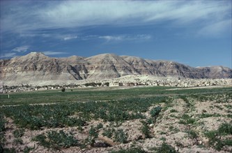 ISRAEL, West Bank, View over landscape toward the Judean Hills near Jericho with houses at the base