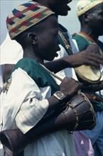 NIGERIA, Music, Child musician playing bongo drums.