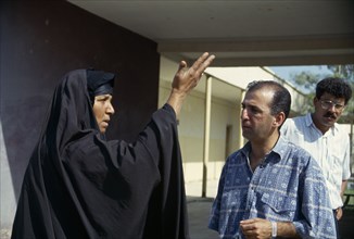 IRAQ, Amara, Marsh Arab woman talking and demonstrating with a hand gesture to a Oxfam engineer.