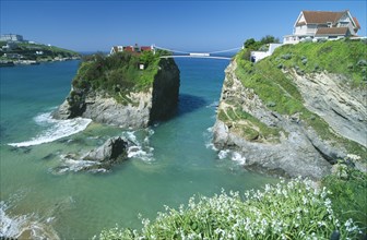 ENGLAND, Cornwall, Newquay, The House in The Sea. Small house atop rock island joined to the