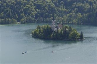 SLOVENIA, Lake Bled, Bled Island seen from the ramparts of the castle with traditional gondolas or