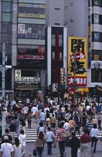 JAPAN, Honshu, Tokyo, Ueno. Busy pedestrian crossing in city street