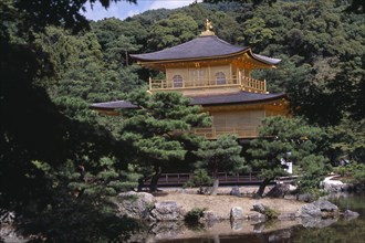 JAPAN, Honshu, Kyoto, Kinkaku Ji Temple aka the Golden Pavilion seen through trees