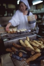 JAPAN, Honshu, Kyoto, Close up of cooking sweetmeats in the kitchen with chef in the background