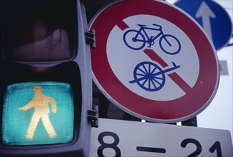 JAPAN, Honshu, Kyoto, Green light of a pedestrian crossing next to bicycle road signs