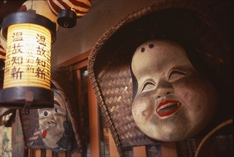 JAPAN, Honshu, Kyoto, Hanging masks and lanterns in a Restaurant entrance