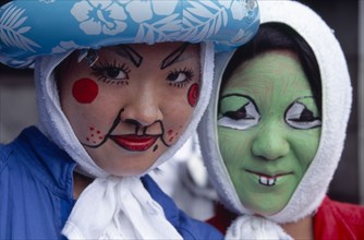 JAPAN, Honshu, Tokyo, Harajuku District. Portrait of two girls smiling wearing face paint