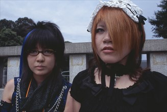 JAPAN, Honshu, Tokyo, Harajuku District. Two teenage girls dressed in Japanese punk style