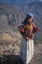 MEXICO, Sierra Huichol, Young Huichol girl in mountain landscape.