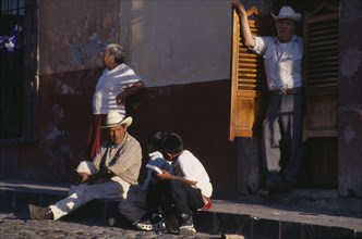 MEXICO, Guanajuato, San Miguel de Allende, Street scene with man and young boys in conversation
