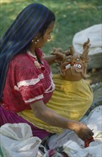 MEXICO, Festivals, Woman making clay figure for Day of the Dead.