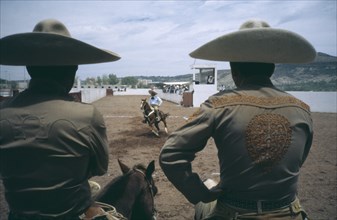 MEXICO, Guanajuato, San Miguel de Allende, Charros or cowboys watching horseman in local rodeo.