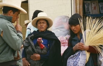 PERU, Cajamarca, Celendin, "Market scene with woman holding turkey, in conversation with man and