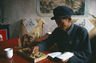 CHINA, Gansu, General, Farner using an abacus to do his accounts.