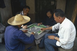 CHINA, Yunnan Province, Kunming, Playing game of majong.