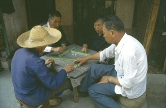 CHINA, Yunnan Province, Kunming, Playing game of majong.