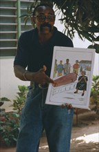 TOGO, Lome, Male teacher using story boards to demonstrate AIDS awareness and safe sex message.