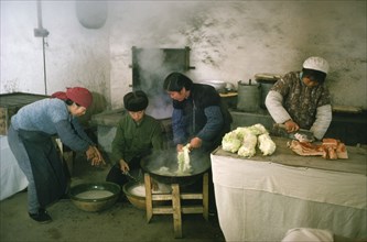 CHINA, Food Perparation, Preparing and cooking meat and vegetables in kitchen of comune.