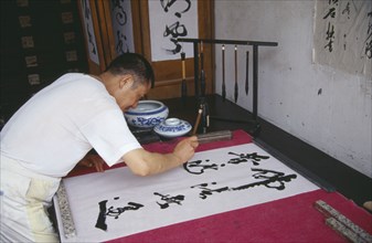 CHINA, Sichuan, Leshan, Calligrapher.