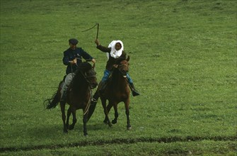 CHINA, Xinjiang Province, Tribal People, Kazakh traditional race on horseback called Kuuz Kuu or