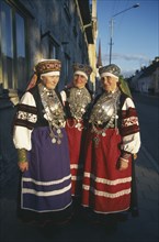 ESTONIA, Rakvere, Three female folk dancers in traditional costume.