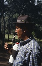 URUGUAY, Farming, Gaucho drinking mate a traditional South American herbal drink made from yerba.