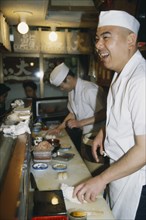 JAPAN, Honshu, Tokyo, Sushi chef at Tsukiji Market.