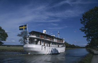 SWEDEN, Gota Canal, The SS Diana cruise boat with Swedish flag flying from upper deck.
