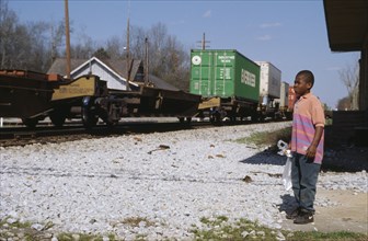 USA, Georgia, Madison, Child watching passing freight train.
