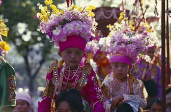 THAILAND, North, Chiang Mai, Two Luk Kaew or Crystal Children in costume carried on shoulders of