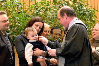 USA, Minnesota, St Paul, Minister performing Naming Ceremony for children in the sanctuary of Unity