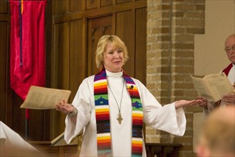 USA, Minnesota, Minneapolis , Pastor greeting the congregation while officiating at an ordination