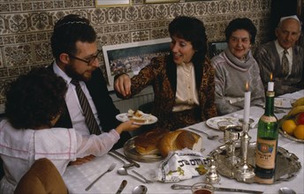 ENGLAND, Religion, Judaism, Jewish New Year.  The chala or bread is passed along table during