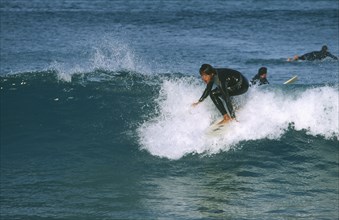 AUSTRALIA, New South Wales, Sydney, Shortboard surfer in sea off Bondi Beach.