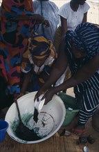 GAMBIA, Work, Women tie dye fabric.