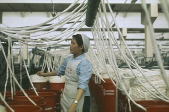 CHINA, Industry, Woman working in cotton factory.