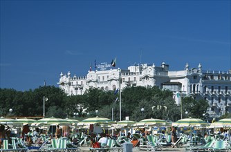 ITALY, Emilia-Romagna, Rimini, "The Grand Hotel with busy beach, parasols and sun loungers in the