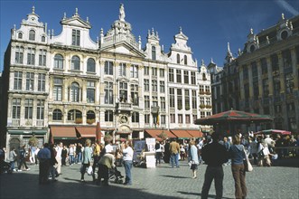 BELGIUM, Brussels, Grand Place lined with cafes with crowds of people and stalls.