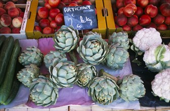 FRANCE, Rhone Alps, Haute Savoie, "Samoens.  Artichokes on market stall also selling cauliflower,
