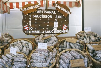 FRANCE, Rhone Alps, Haute Savoie, Samoens.  Baskets of different flavoured pork sausages for sale