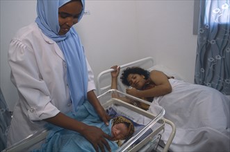 SOMALILAND, Hargeisa, Nurse attending mother and new born baby in Edna Adan maternity hospital.