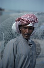 KUWAIT, People, Portrait of man wearing traditional red and white arab headscarf