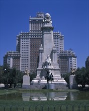 SPAIN, Madrid State, Madrid , Plaza Espana. Stone obelisk with statue of Miguel de Cervantes seen