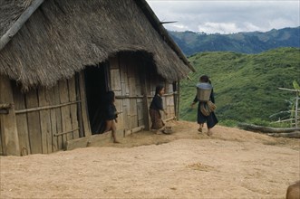LAOS, Traditional Housing, Meo children outside thatched house in village near Luang Prabang.